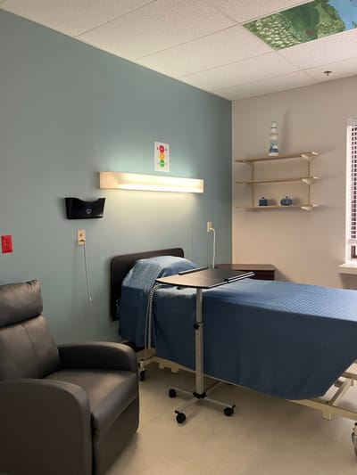 Interior of a resident room with a bed and chair