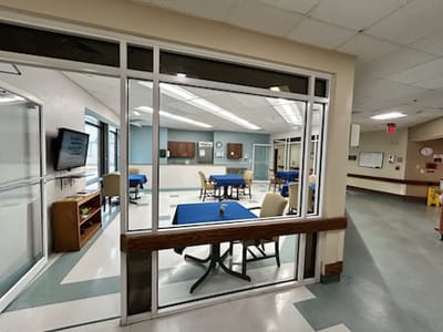 Common area with tables and chairs set up for activities