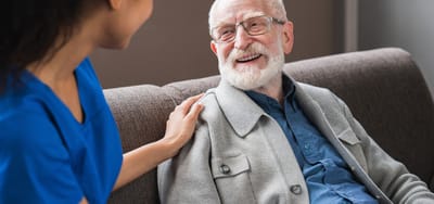 Staff member interacting with a resident in a cozy setting
