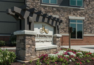 Exterior sign of Kensington Reston with flowers