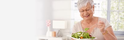 Senior woman enjoying a salad in a bright interior