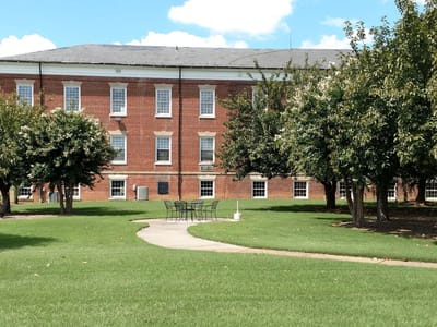 Outdoor pathway leading to a brick building