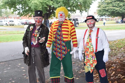 Clowns entertaining in an outdoor area during an event