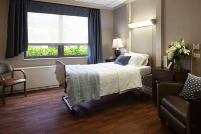 A well-appointed resident room with a bed and decor