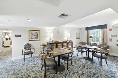 Common area with tables and seating in a light-filled room