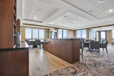 Bright common area with seating and large windows