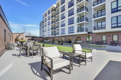 Outdoor seating area with lounge furniture and green space