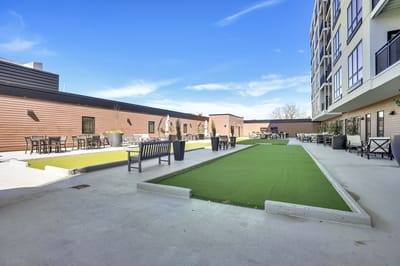 Outdoor space with seating and green areas.