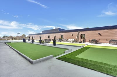 Outdoor green space with seating and recreational areas