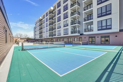 View of outdoor tennis courts and building exterior