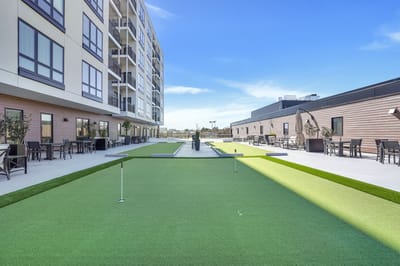 Outdoor space with green lawn and seating areas