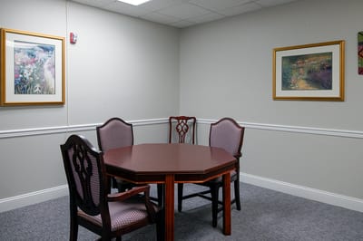 A quiet meeting room with a table and chairs