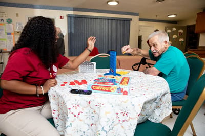 Residents playing Connect 4 in a common area