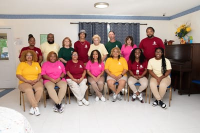 Staff members posing in a facility common area