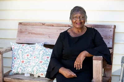 Woman sitting on a bench outside the facility