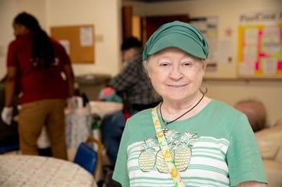 Resident smiling in a facility common area
