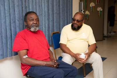 Two residents chatting in a common area