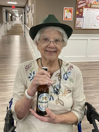 Resident enjoying a drink in a hallway