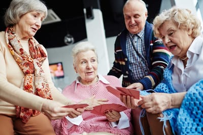 Residents engaging in a card game together