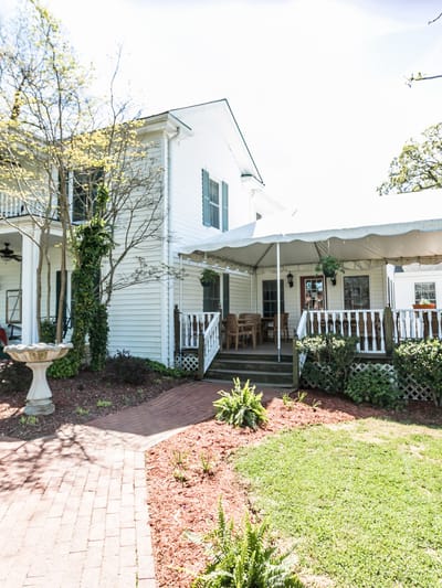 Building exterior with outdoor seating area and garden