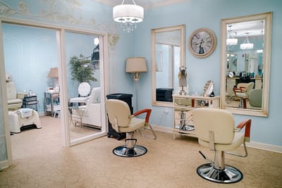 Bright salon area with elegant chairs and mirrors