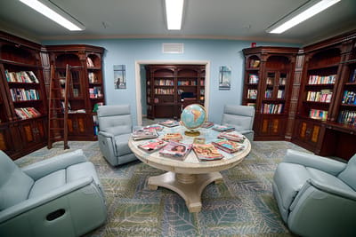 Cozy interior of a library with reading chairs and bookshelves