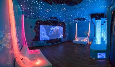 Colorful sensory room with aquatic theme and lighting