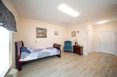 Private resident room with bed and chair