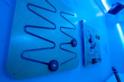 Interactive activity boards on a blue wall