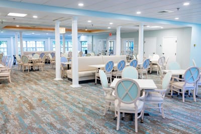 Bright dining room with white furniture and carpet