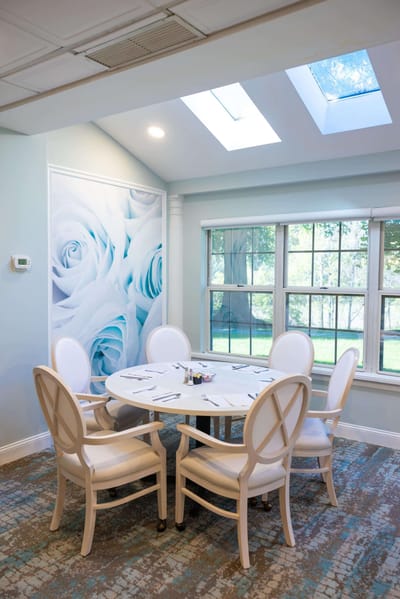 Bright common area with a round table and chairs