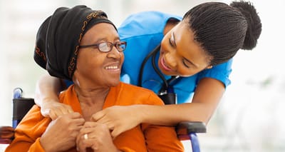 A caregiver interacting with a resident in a warm setting
