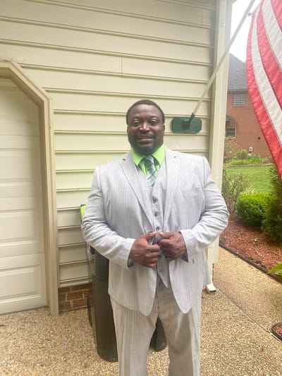 A man in a suit standing outside a building