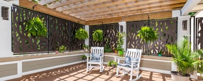 Outdoor seating area with rocking chairs and plants