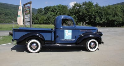 Vintage truck with facility logo parked outdoors