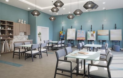 Bright art studio with tables and paintings on display