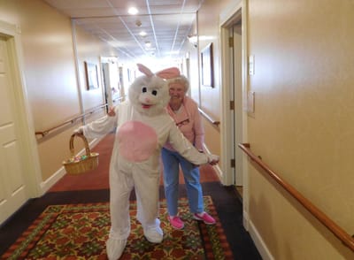 Residents celebrating with an Easter Bunny costume in the hallway