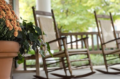 Rocking chairs on a porch with flowers