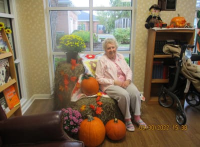 Resident decorating for fall in a cozy common area