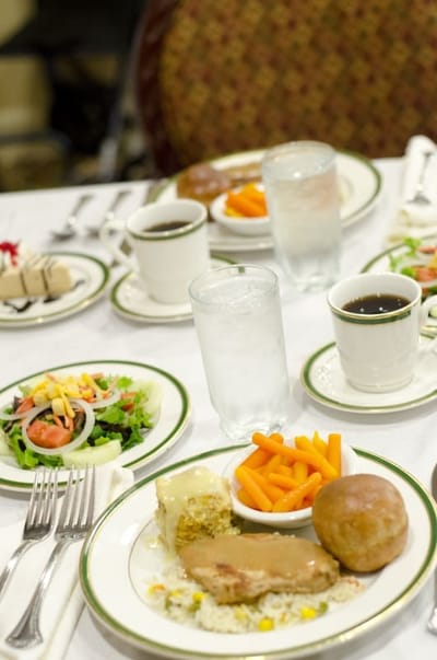 A beautifully arranged dining table with meals and beverages