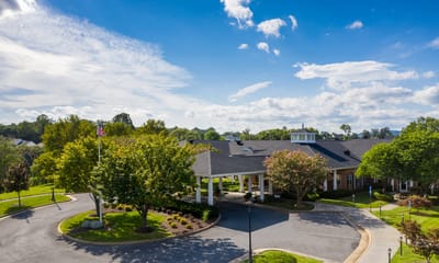 Aerial view of a senior living facility with gardens and walkways