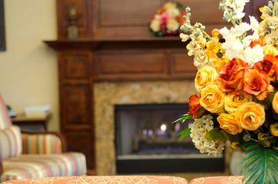 Cozy common area with fireplace and floral arrangement