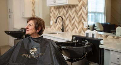 Senior woman receiving a haircut in a salon