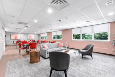 Bright common area with modern seating and decor.