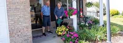 Residents chatting outside with flowers