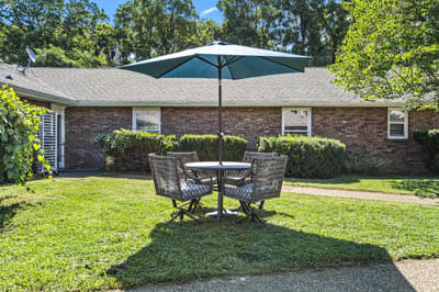 Outdoor seating area with a table and umbrella