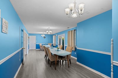 Bright dining area with blue walls and tables
