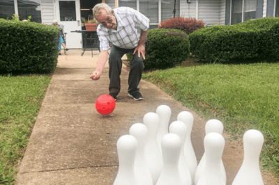 Senior resident bowling in the garden area