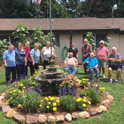 Residents enjoying the garden area by a fountain