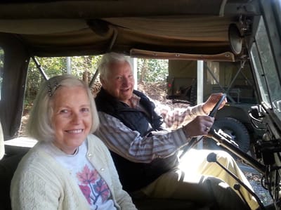 Two smiling seniors sitting in a vehicle
